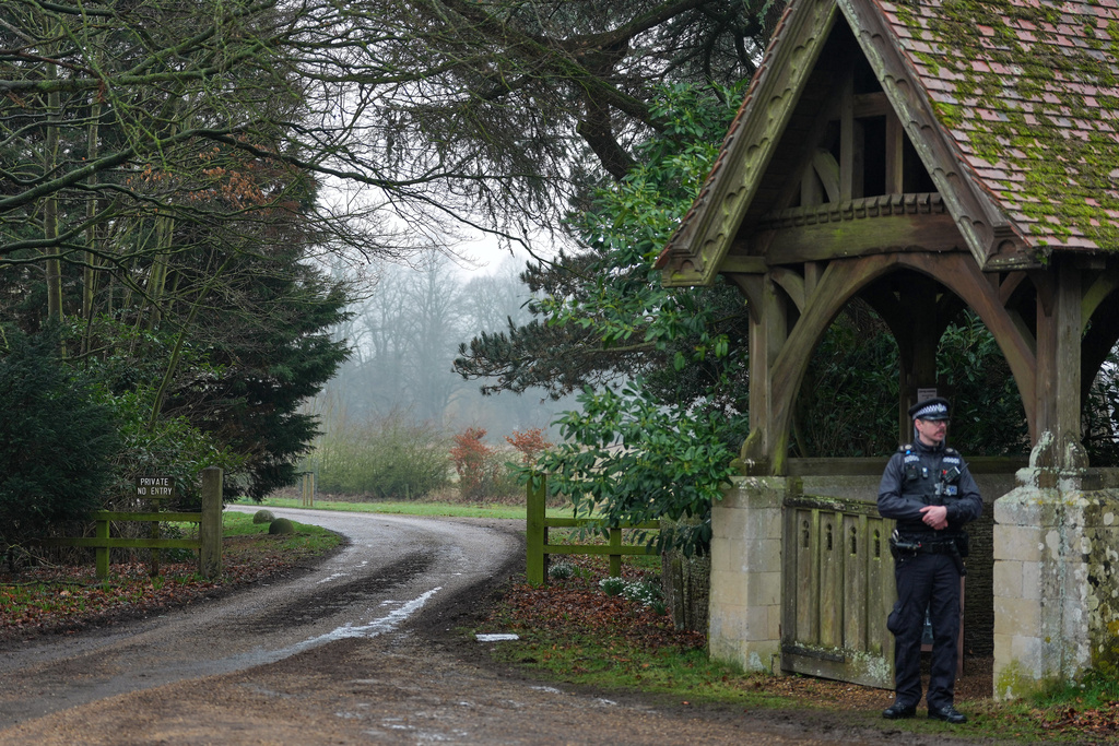 A Police officer guards the entrance to Wood Farm at the Sandringham Royal Estate in Sandringham, England, Thursday, Feb. 19, 2026 after Andrew Mountbatten-Windsor was arrested by British police on suspicion of misconduct in public office. (AP Photo/Alastair Grant)