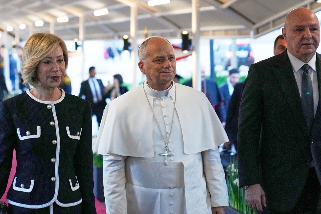 Pope Leo XIV, center, is escorted by Lebanese President Joseph Aoun, right, First Lady Nehmat Aoun before arrival ceremony at Beirut International Airport in Beirut, Lebanon, Sunday, Nov. 30, 2025.(AP Photo/Hussein Malla)