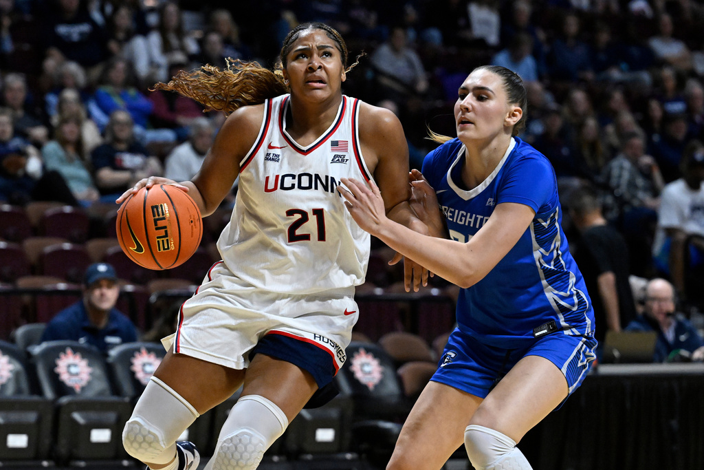 UConn forward Sarah Strong (21) looks to shoot at Creighton center Elizabeth Gentry defends during first half of an NCAA college basketball game in the semifinals of the Big East tournament, Sunday, March 8, 2026, in Uncasville, Conn. (AP Photo/Jessica Hill)
