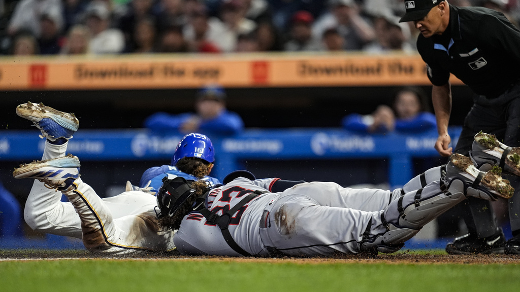 Minnesota Twins Austin Martin (16) scores on a loose ball against Cleveland Guardians catcher Bo Naylor (23) in the sixth inning of a baseball game, Friday, Sept. 19, 2025, in Minneapolis. (AP Photo/Mike Stewart)