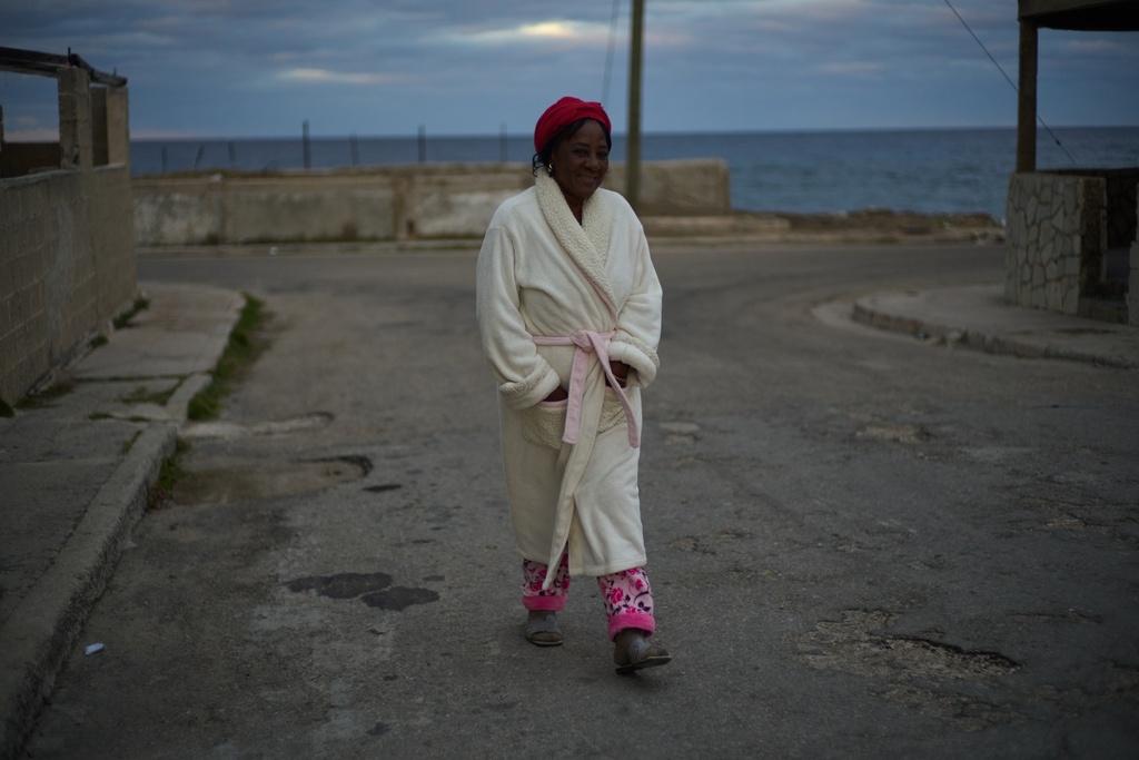 Gladys Delgado walks outside during a scheduled power outage in Santa Cruz del Norte, Cuba, early Tuesday, Feb. 3, 2026. (AP Photo/Ramon Espinosa)