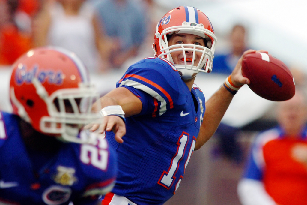FILE - Florida quarterback Tim Tebow throws a touchdown pass to receiver Louis Murphy during the first quarter of an NCAA college football game against Georgia on Oct. 27, 2007, in Jacksonville, Fla. (AP Photo/Stephen Morton, File)
