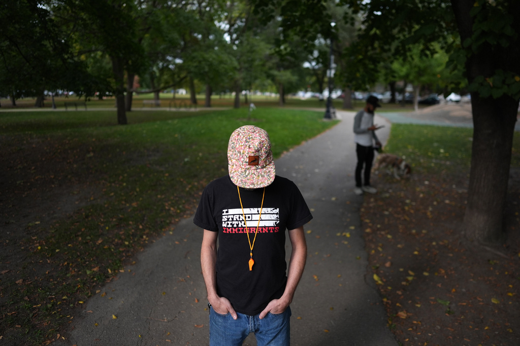 A federal employee, who did not want to be identified for fear of workplace retaliation, poses for a portrait in Palmer Square Park, near where he and other neighborhood volunteers stand watch outside schools during student arrival and dismissal hours to watch for Immigration and Customs Enforcement vehicles, in Chicago's Logan Square neighborhood, Tuesday, Oct. 14, 2025. (AP Photo/Rebecca Blackwell)