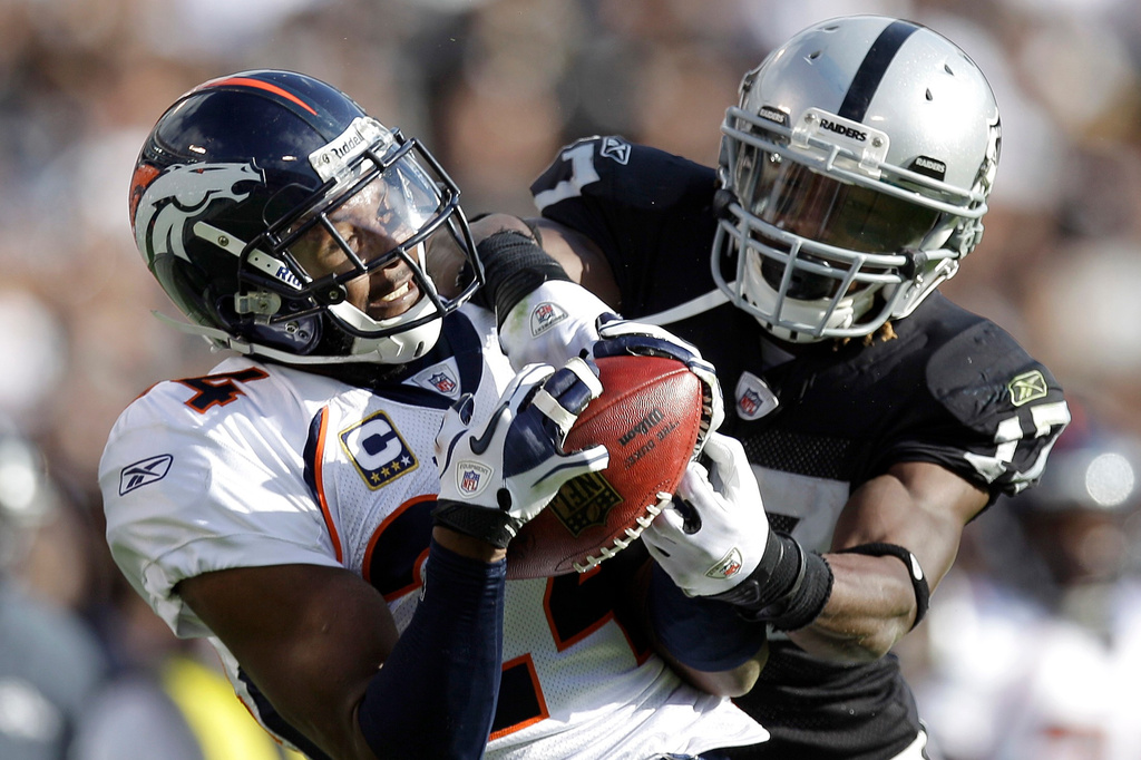 FILE - Denver Broncos cornerback Champ Bailey, right, intercepts a pass intended for Oakland Raiders wide receiver Denarius Moore in the second quarter of an NFL football game in Oakland, Calif., Nov. 6, 2011. (AP Photo/Ben Margot, File)