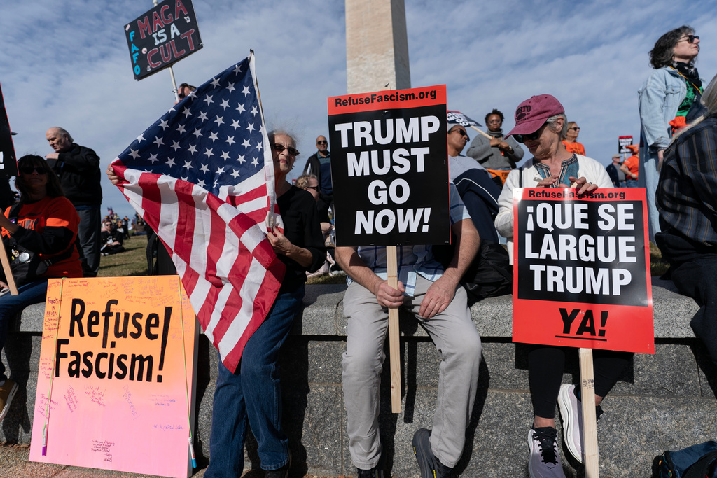 Demonstrators protest at the Washington Monument during a Trump Must Go Now rally at the National Mall in Washington, Wednesday, Nov. 5, 2025. (AP Photo/Jose Luis Magana)