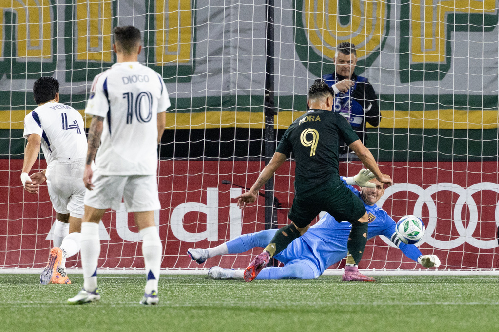 Portland Timbers forward Felipe Mora, middle, scores a goal against Real Salt Lake during the first half of an MLS soccer match Wednesday, Oct. 22, 2025, in Portland, Ore. (AP Photo/Howard Lao)