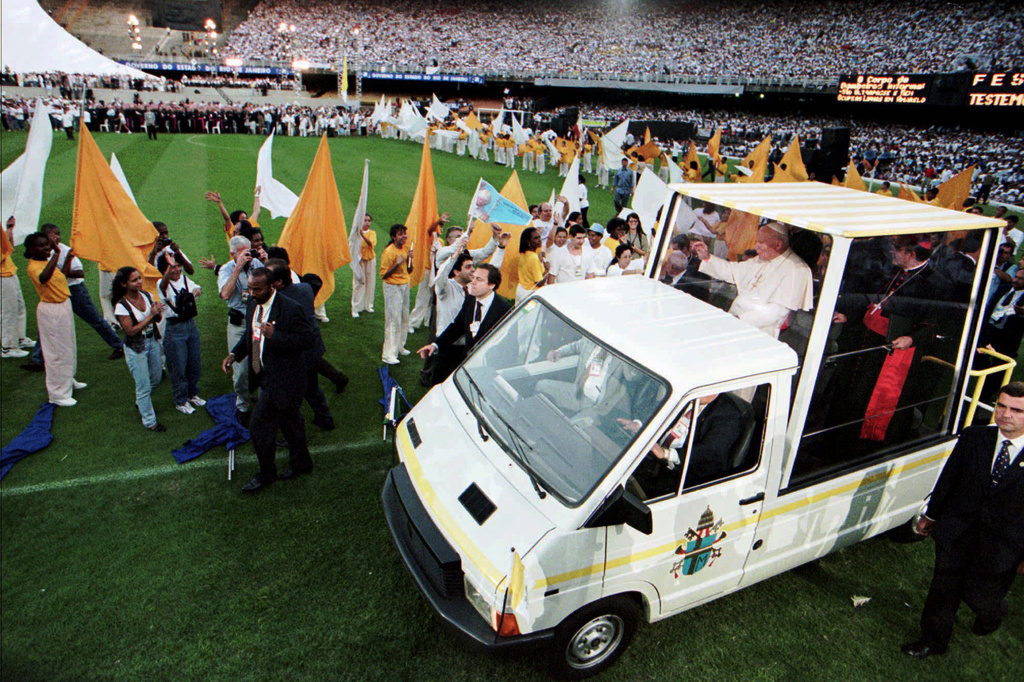 FILE - Pope John Paul II waves to worshippers as he arrives to Rio de Janeiro's Maracana Stadium on Oct. 4, 1997. (AP Photo/Dario Lopez Mills, File)
