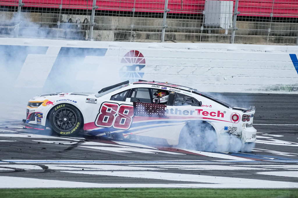 Shane van Gisbergen does a burnout after winning a NASCAR Cup Series auto race at Charlotte Motor Speedway, Sunday, Oct. 5, 2025, in Concord, N.C. (AP Photo/Matt Kelley)