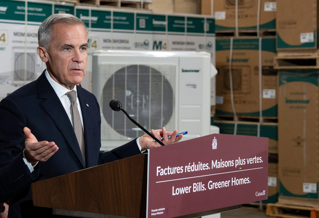 Prime Minister Mark Carney announces a new federal heat pump rebate program while visiting Dettson, a manufacturer of residential and commercial HVAC systems in Sherbrooke, Quebec, Thursday, Oct. 8, 2026. (Christinne Muschi/The Canadian Press via AP)