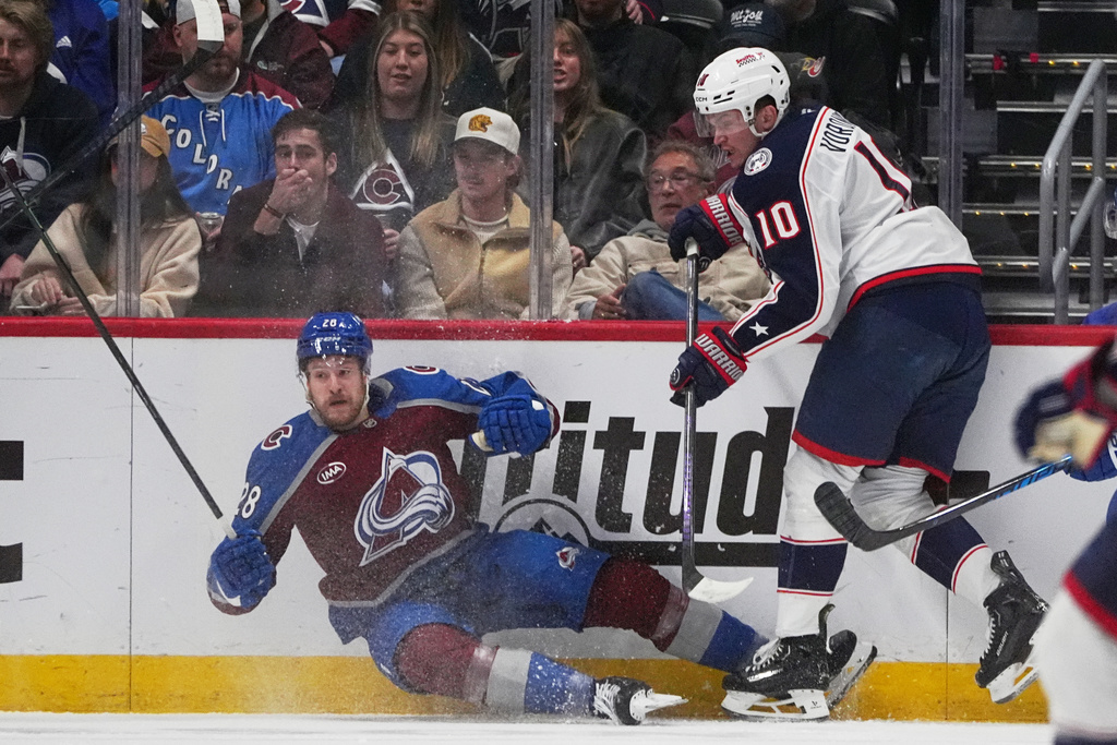 Columbus Blue Jackets left wing Dmitri Voronkov, right, checks Colorado Avalanche defenseman Ilya Solovyov in the first period of an NHL hockey game, Saturday, Jan. 10, 2026, in Denver. (AP Photo/David Zalubowski)