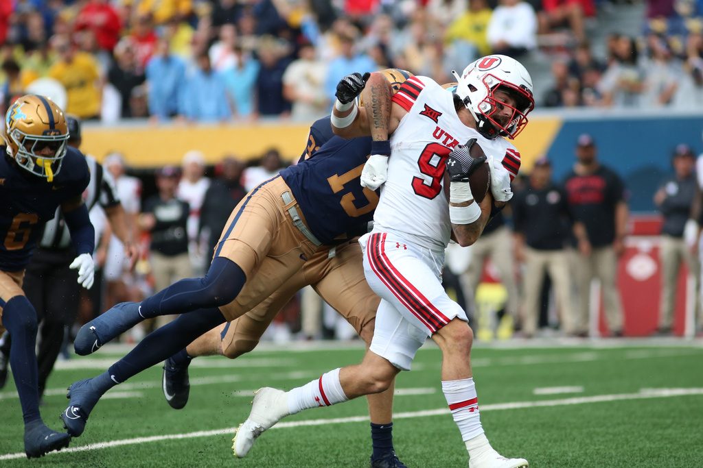 Utah Utes wide receiver Ryan Davis (9) picks up yards after a catch during the first half of an NCAA college football game against West Virginia Mountaineers, Saturday, Sept, 27, 2025, in Morgantown, W.Va. (AP Photo/ William Wotring)