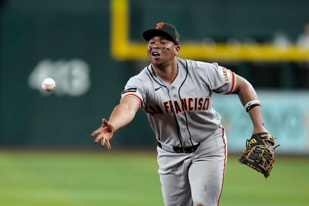 San Francisco Giants first baseman Rafael Devers tosses to first base to get Arizona Diamondbacks' Jorge Barrosa out during the fourth inning of a baseball game, Wednesday, May 20, 2026, in Phoenix. (AP Photo/Ross D. Franklin)