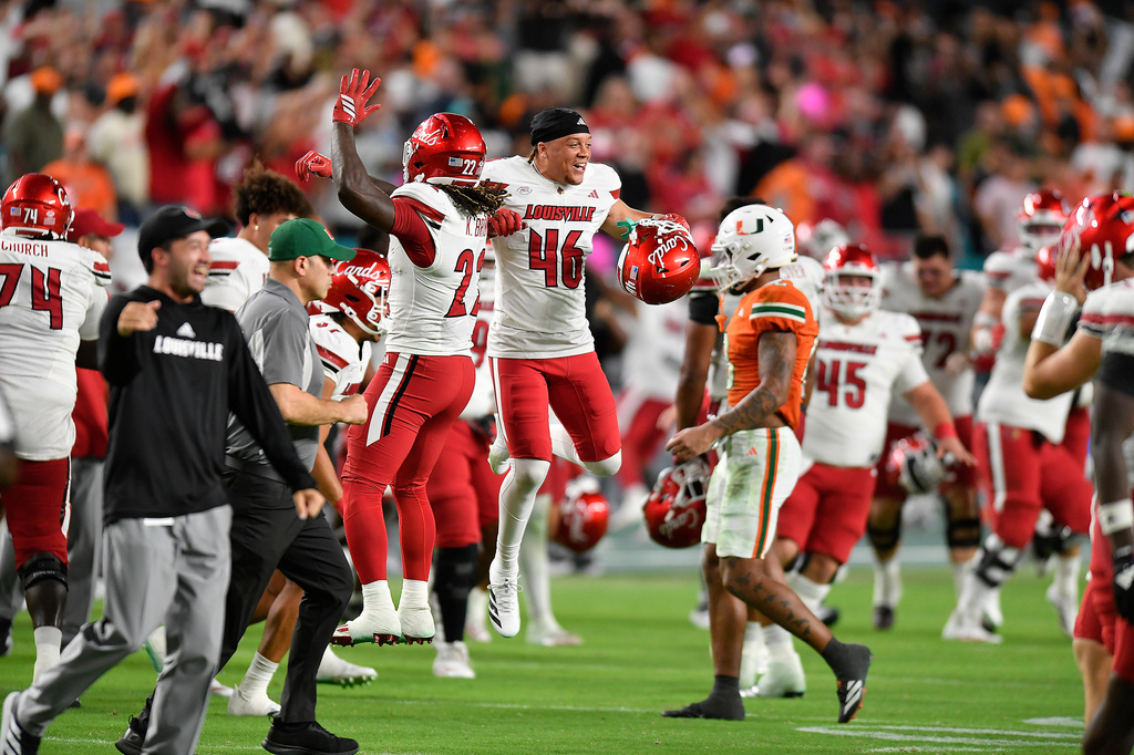 FILE - Louisville players celebrate beating Miami in an NCAA college football game, Oct. 17, 2025, in Miami Gardens, Fla. (AP Photo/Michael Laughlin, File)
