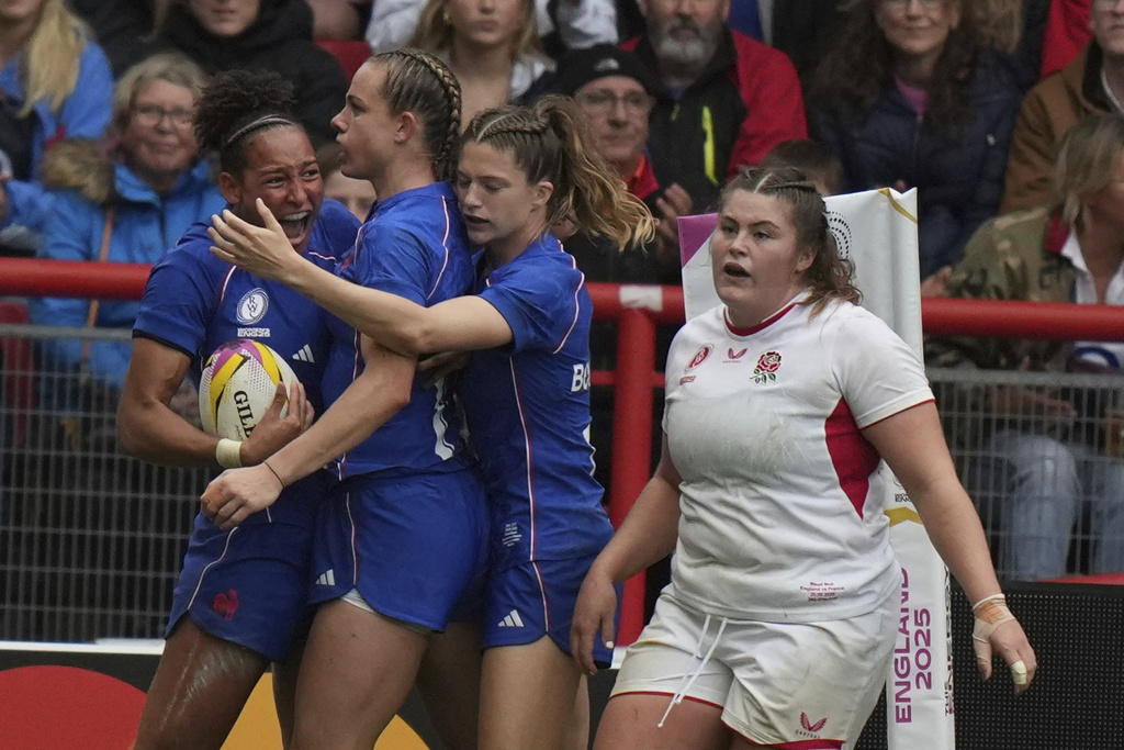 France's Kelly Arbey, left, celebrates her try during the Women's Rugby World Cup 2025 semifinal match between France and England in Bristol, England, Saturday, Sept. 20, 2025.(AP Photo/Alastair Grant)