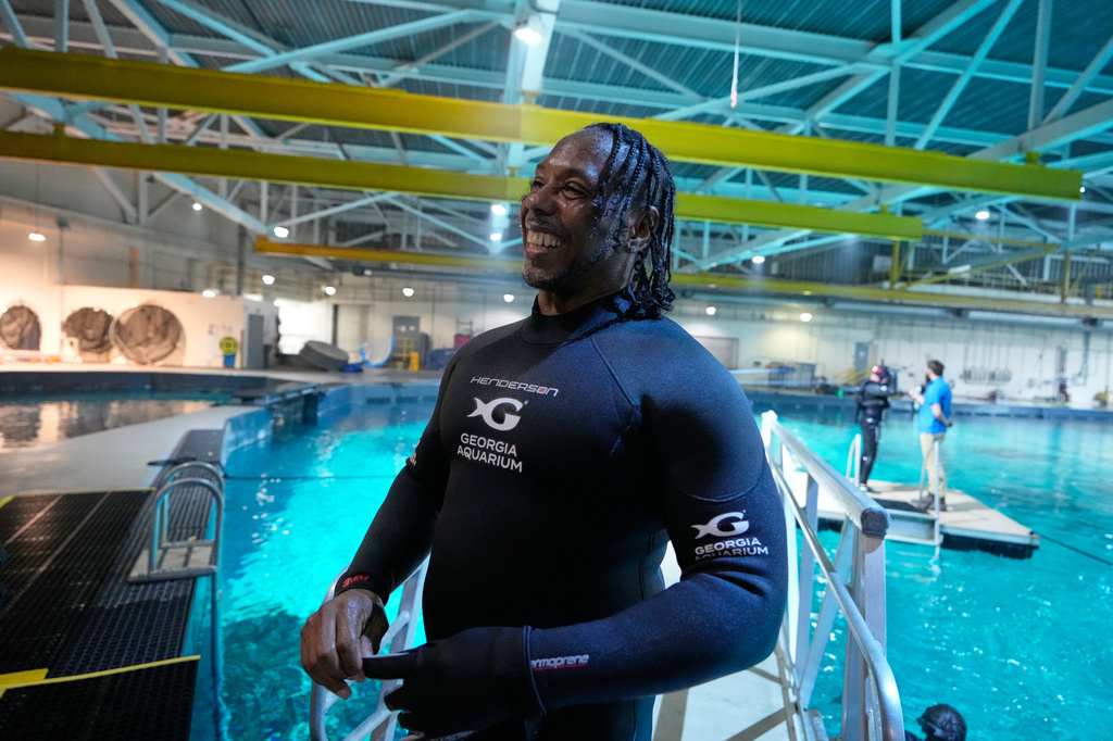 Lee Menzies, with the Wounded Warrior Project, smiles after swimming at the Georgia Aquarium as a part of the Veterans Immersion Program, Wednesday, May 6, 2026, in Atlanta. (AP Photo/Brynn Anderson)