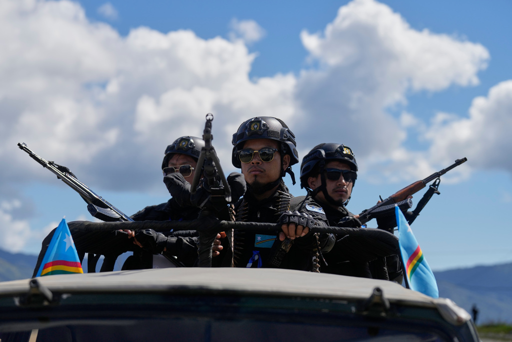 Armed cadres of the National Socialist Council of Nagaland (Isak-Muivah) keep guard as they wait for their leader Thuingaleng Muivah in Ukhrul, in the northeastern Indian state of Manipur, Wednesday, Oct. 22, 2025. (AP Photo/Anupam Nath)
