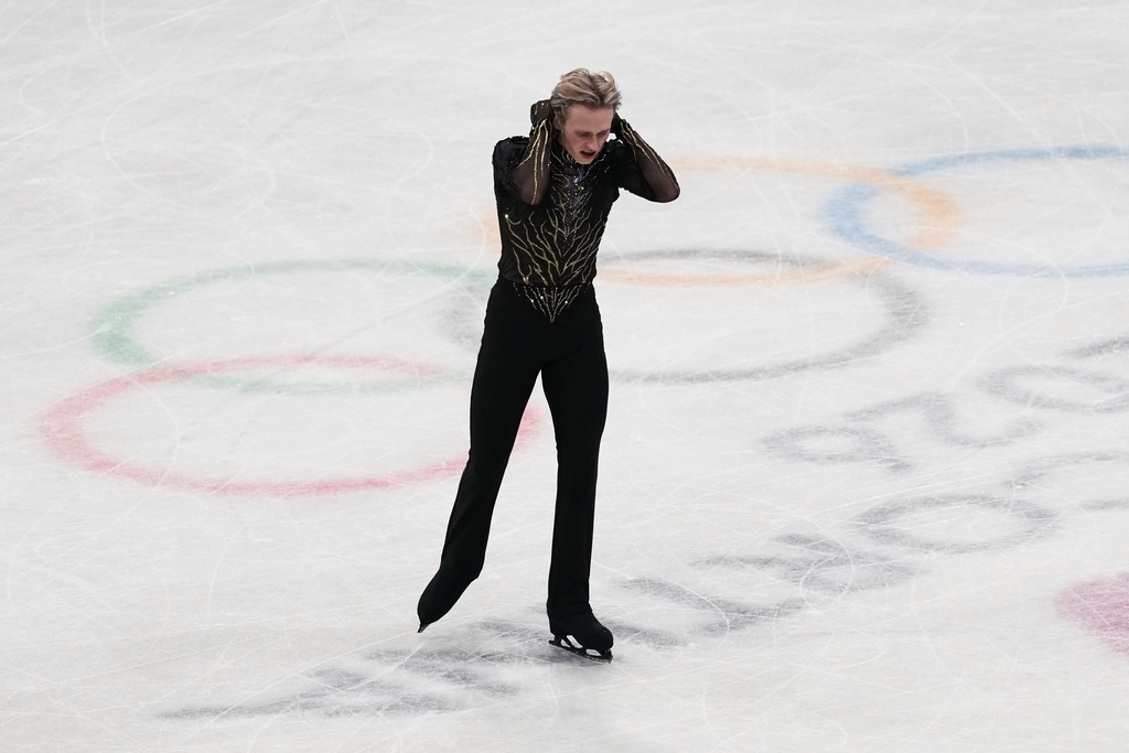 Ilia Malinin of the United States does a back flip while competing during the men's free skate program in figure skating at the 2026 Winter Olympics, in Milan, Italy, Friday, Feb. 13, 2026. (AP Photo/Stephanie Scarbrough)
