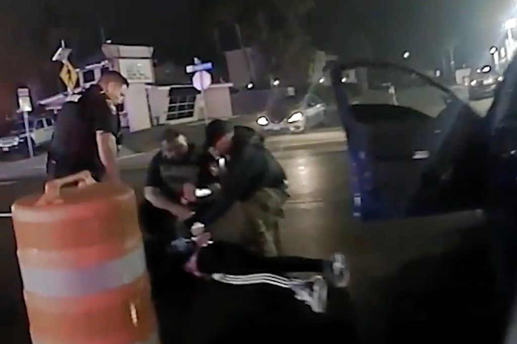 In this image made from video provided by the Texas Department of Public Safety shows law enforcement officials surround Ruben Ray Martinez after he was shot by Homeland Security Investigations Special Agent Jack Stevens and pulled from his vehicle at a roadblock in South Padre Island, Texas, on March 15, 2025. (Miguel Leal/Texas Department of Public Safety via AP)
