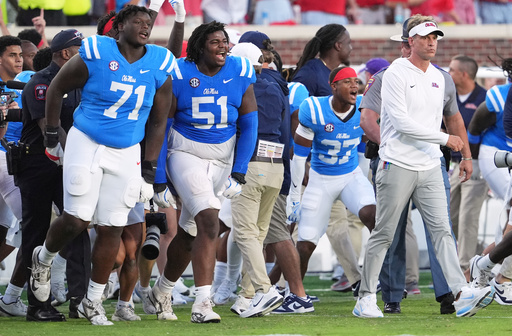 Mississippi head coach Lane Kiffin, right, leads Mississippi offensive lineman PJ Wilkins (71), defensive tackle Zxavian Harris (51), and safety Cortez Thomas (37) onto the field following their win over LSU during an NCAA college football game in Oxford, Miss., Saturday, Sept. 27, 2025. (AP Photo/Rogelio V. Solis) Mississippi head coach Lane Kiffin, right, leads Mississippi offensive lineman PJ Wilkins (71), defensive tackle Zxavian Harris (51), and safety Cortez Thomas (37) onto the field following their win over LSU during an NCAA college football game in Oxford, Miss., Saturday, Sept. 27, 2025. (AP Photo/Rogelio V. Solis)