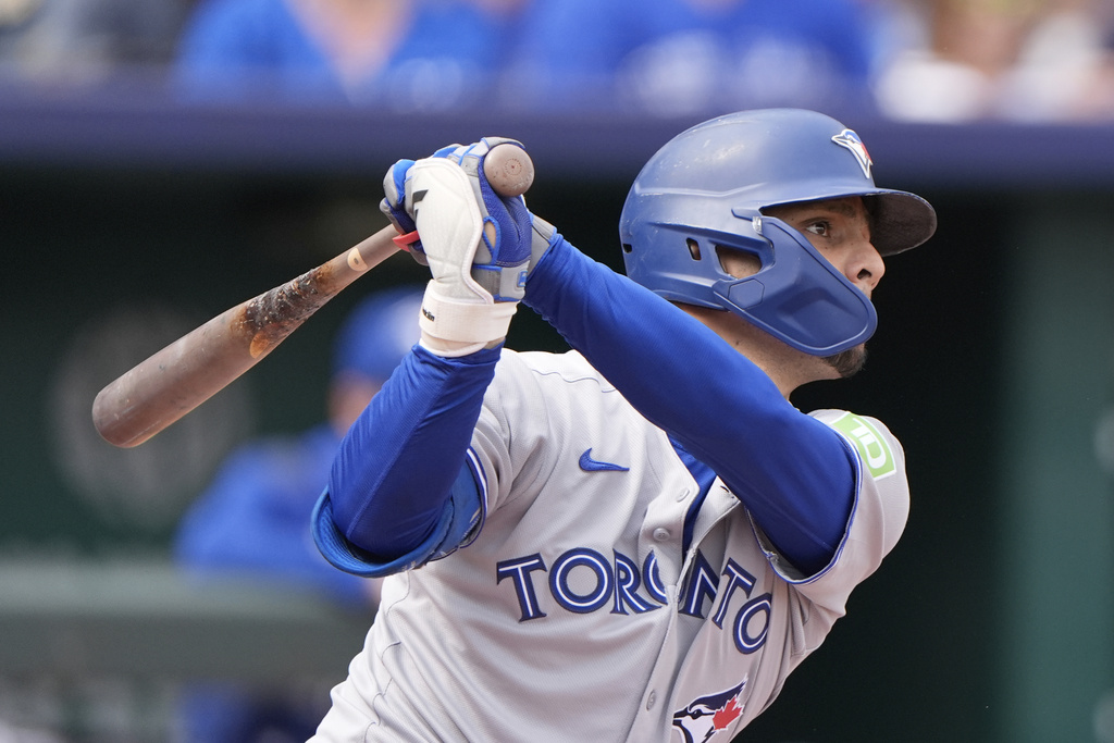 Toronto Blue Jays' Andres Gimenez watches his RBI single during the second inning of a baseball game against the Kansas City Royals, Sunday, Sept. 21, 2025, in Kansas City, Mo. (AP Photo/Charlie Riedel)