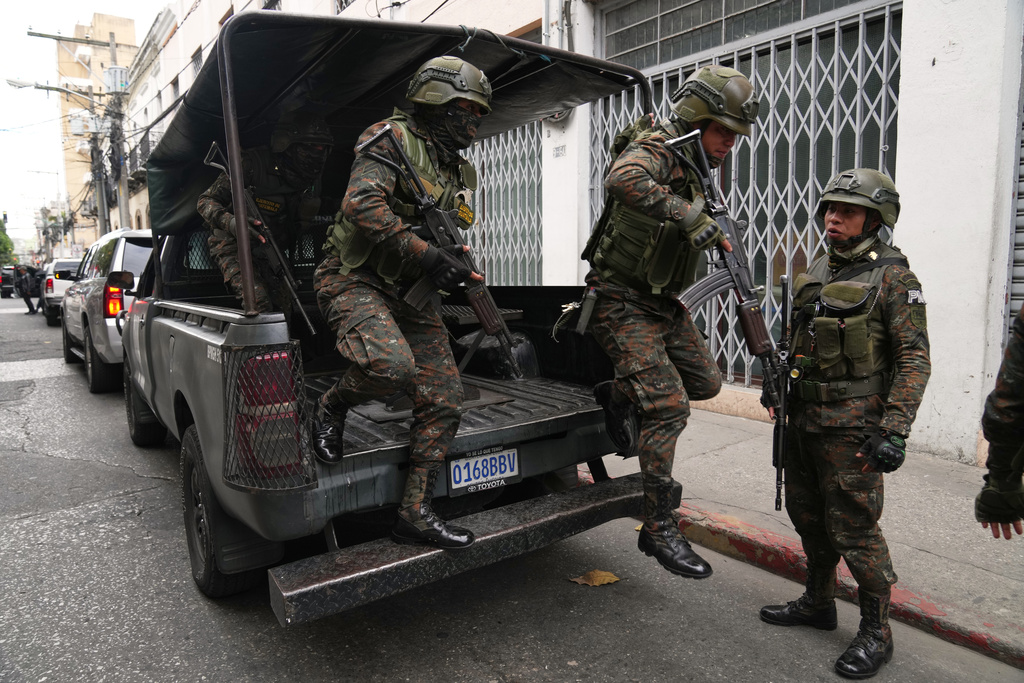 Deployed soldiers exit a vehicle around Congress in Guatemala City, Monday, Jan. 19, 2026, after President Bernardo Arévalo declared a state of emergency. (AP Photo/Moises Castillo)