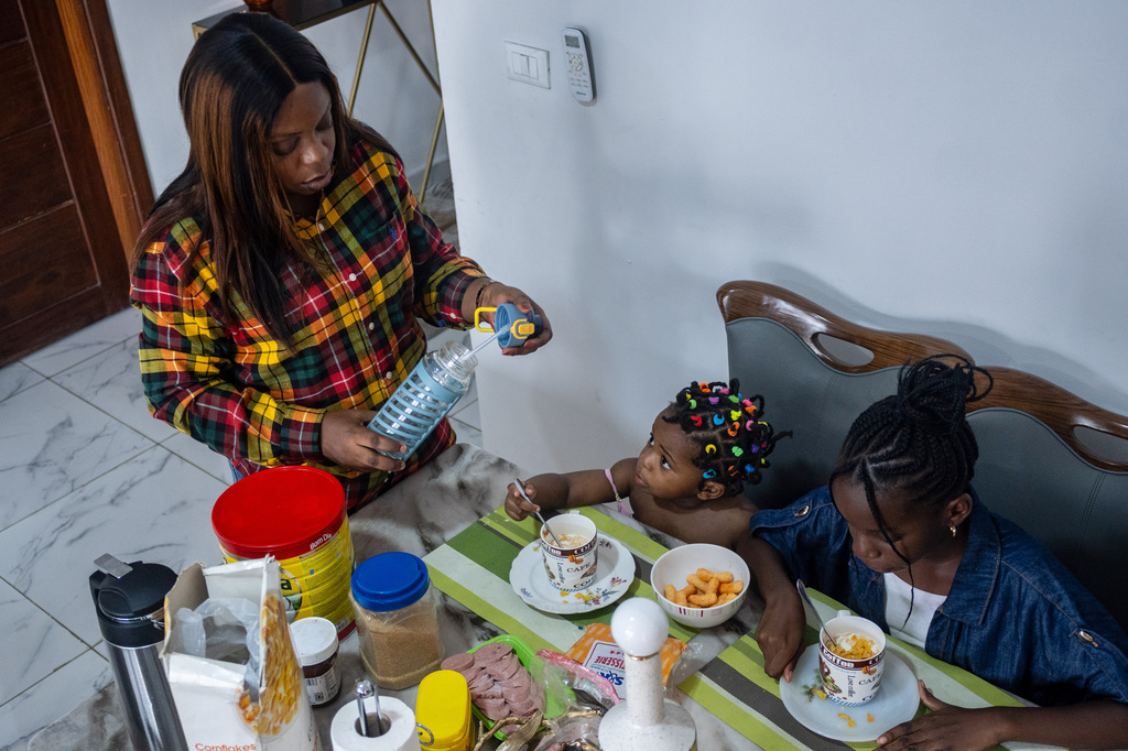 Gloria Masanka, a mother of two daughters, spends time with them at home in Kinshasa, Congo, Monday, April 6, 2026. (AP Photo/Samy Ntumba Shambuyi)