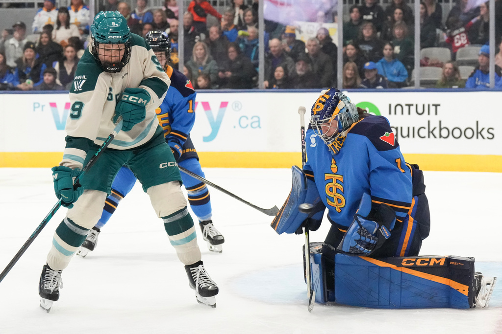 Toronto Sceptres goaltender Raygan Kirk (1) makes a save in front of Seattle Torrent's Jessie Eldridge (9) during third-period PWHL hockey game action in Toronto, Sunday March 15, 2026. (Chris Young/The Canadian Press via AP)