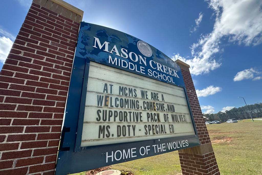 A sign outside Mason Creek Middle School in Winston, Ga., displays a message, Wednesday March 11, 2026. (AP Photo/Kate Brumback)