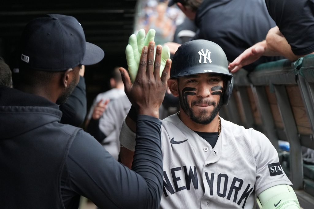 New York Yankees' José Caballero is greeted in the dugout after hitting a two-run home run against the Chicago Cubs during the third inning of a baseball game Sunday, Aug. 2, 2026, in Chicago. (AP Photo/David Banks)