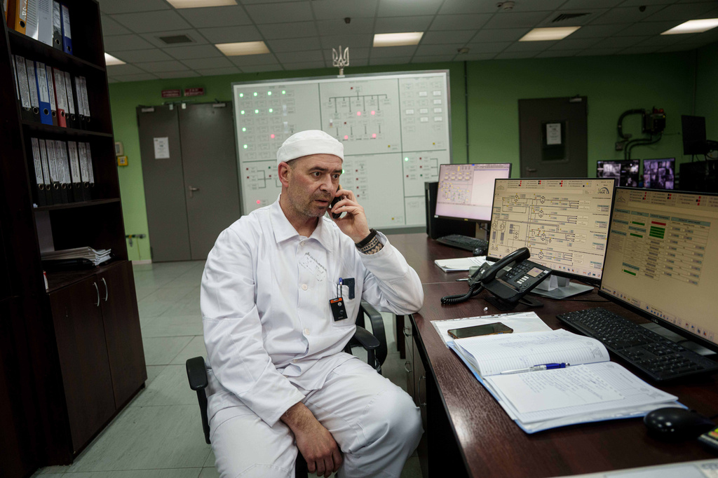 Serhii Bokov, senior manager of operations for the New Safe Confinement structure, which was built to prevent radiation leaks from the damaged reactor at the Chernobyl nuclear power plant in Ukraine, speaks on the phone on April 6, 2026. (AP Photo/Evgeniy Maloletka)