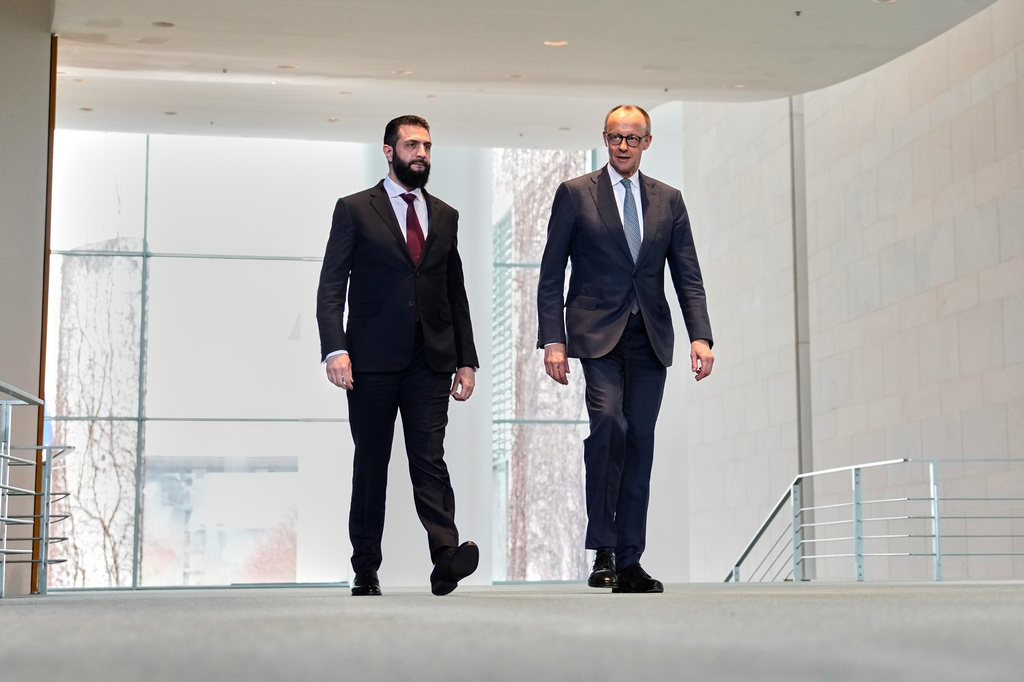 German Chancellor Friedrich Merz, right, and Syrian President Ahmad al-Sharaa arrive for a press conference in Berlin, Germany, Monday, March 30, 2026. (AP Photo/Markus Schreiber)