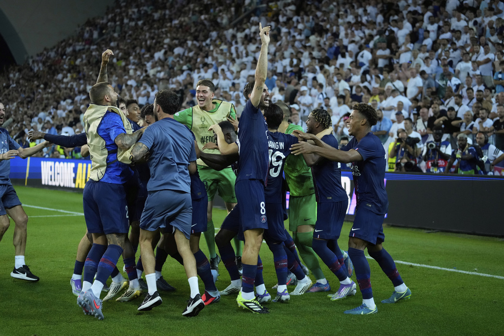 PSG players celebrate following a penalty shootout to win the UEFA Super Cup soccer match between Paris Saint-Germain and Tottenham Hotspur in Udine, Italy, Wednesday, Aug. 13, 2025. (AP Photo/Darko Bandic)
