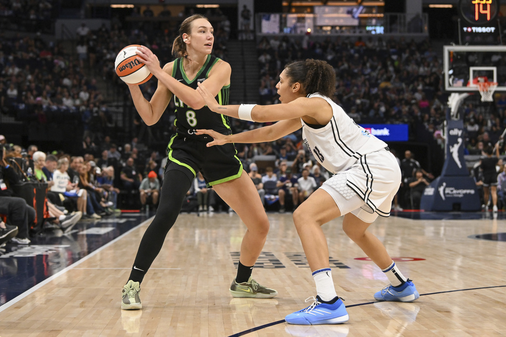 Minnesota Lynx forward Alanna Smith (8) looks to pass the ball over Golden State Valkyries forward Janelle Salaun (13) during the second half of Game 1 in the first round of the WNBA basketball playoffs Sunday, Sept. 14, 2025, in Minneapolis. (AP Photo/Craig Lassig)