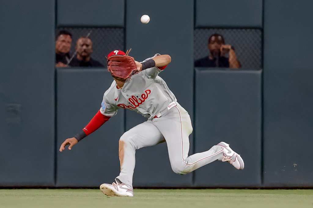 Philadelphia Phillies center fielder Justin Crawford (2) catches a fly ball hit by Atlanta Braves Drake Baldwin during the sixth inning of a baseball game, Friday, April 24, 2026, in Atlanta. (AP Photo/Erik S. Lesser)