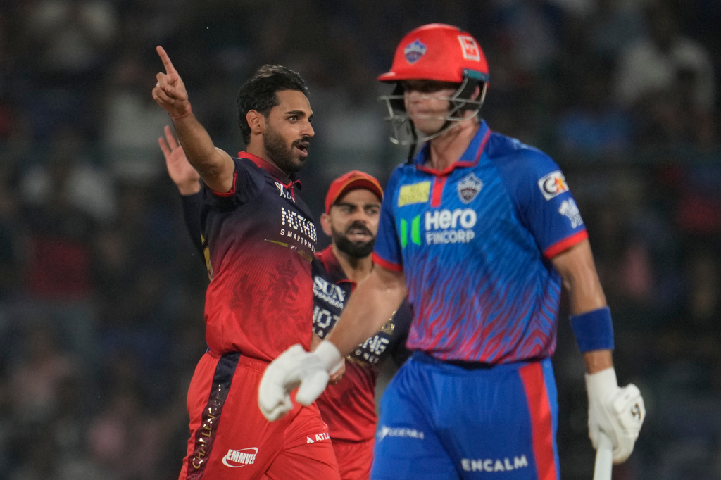 Royal Challengers Bengaluru's Bhuvneshwar Kumar, left, celebrates the wicket of Delhi Capitals' Tristan Stubbs, right, during the Indian Premier League cricket match between Delhi Capitals and Royal Challengers Bengaluru in Delhi, India, Monday, April 27, 2026. (AP Photo/Manish Swarup)