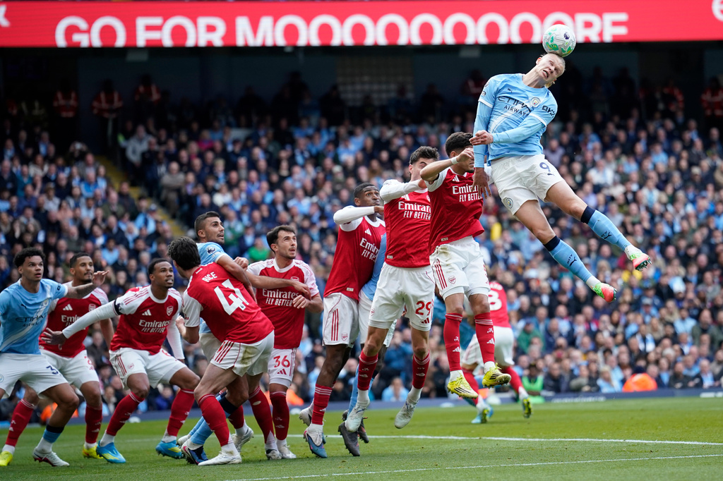Manchester City's Erling Haaland heads the ball during the English Premier League soccer match between Manchester City and and Arsenal, in Manchester, England, Sunday, April 19, 2026. (AP Photo/Dave Thompson)