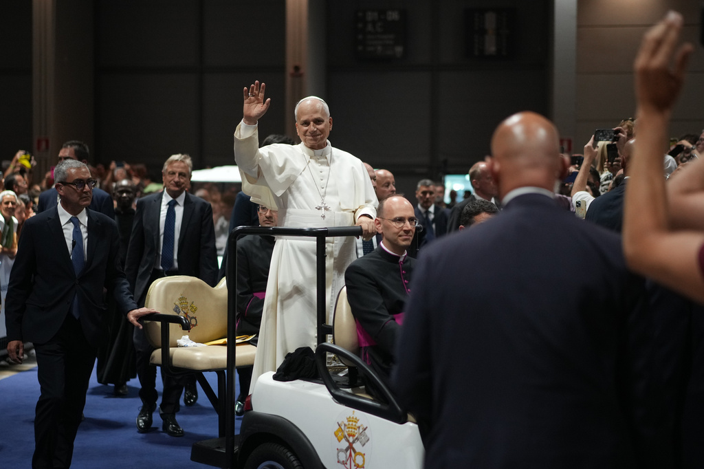 Pope Leo XIV greets faithful as he arrives at the 47th Meeting for Friendship Among Peoples in Rimini, Italy, Saturday, Aug. 22, 2026. (AP Photo/Andrew Medichini)