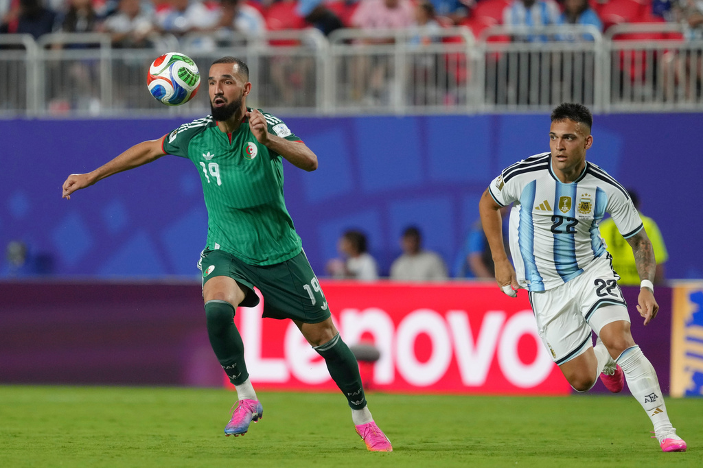 Algeria's Nabil Bentaleb (19) plays the ball against Argentina's Lautaro Martinez (22) during the World Cup Group J soccer match between Argentina and Algeria in Kansas City, Mo., Tuesday, June 16, 2026. (AP Photo/Ed Zurga)