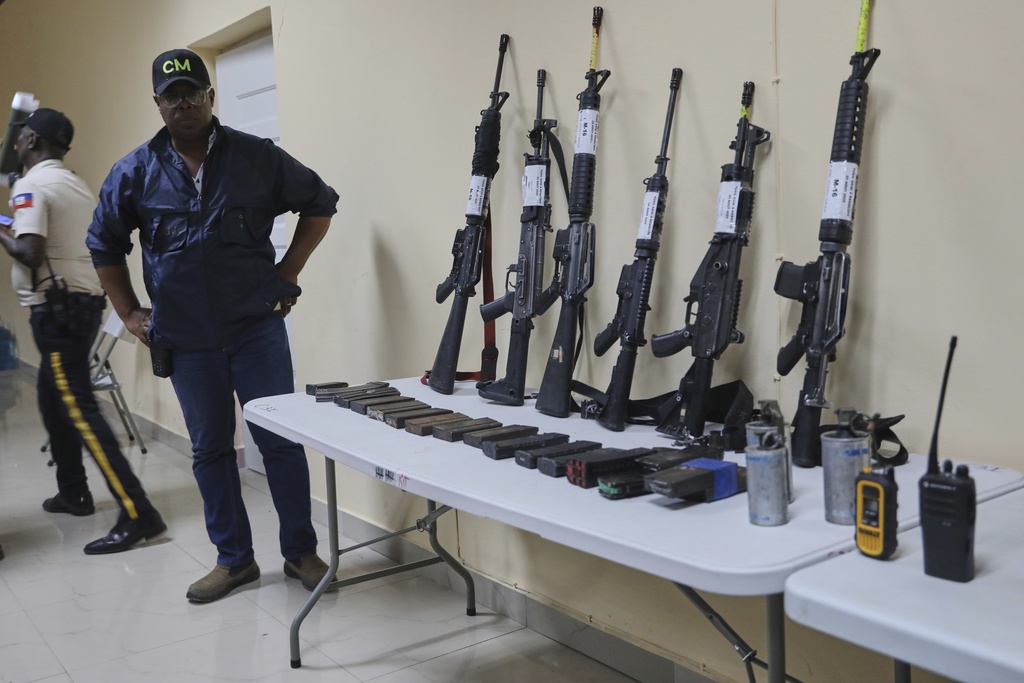 Weapons that police say were seized from alleged gang members sit on display for the media during a press conference at police headquarters in Port-au-Prince, Haiti, Tuesday, Aug. 26, 2025.(AP Photo/Odelyn Joseph)