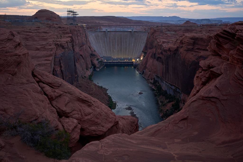 The Colorado River flows beneath the Glen Canyon Dam at the Glen Canyon National Recreation Area, Tuesday, July 14, 2026, near Page, Nev. (AP Photo/John Locher)