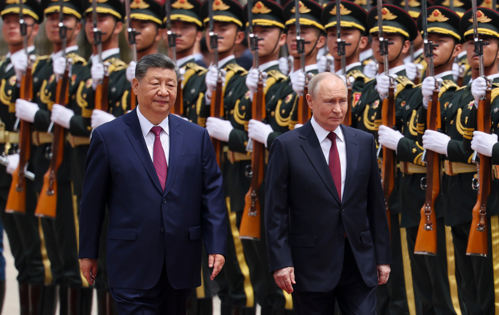 Russian President Vladimir Putin, right, and Chinese President Xi Jinping inspect an honor guard during a welcoming ceremony at the Great Hall of the People in Beijing Wednesday, May 20, 2026. (Maxim Shemetov/Pool Photo via AP)