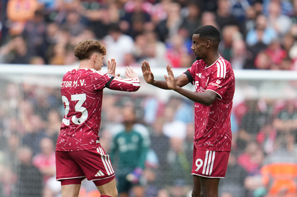 Liverpool's Alexander Isak, right, celebrates with Liverpool's Victor Munoz after scoring his side's opening goal during the English Premier League soccer match between Liverpool and Nottingham Forest in Liverpool, England, Saturday, Aug. 29, 2026. (AP Photo/Jon Super)