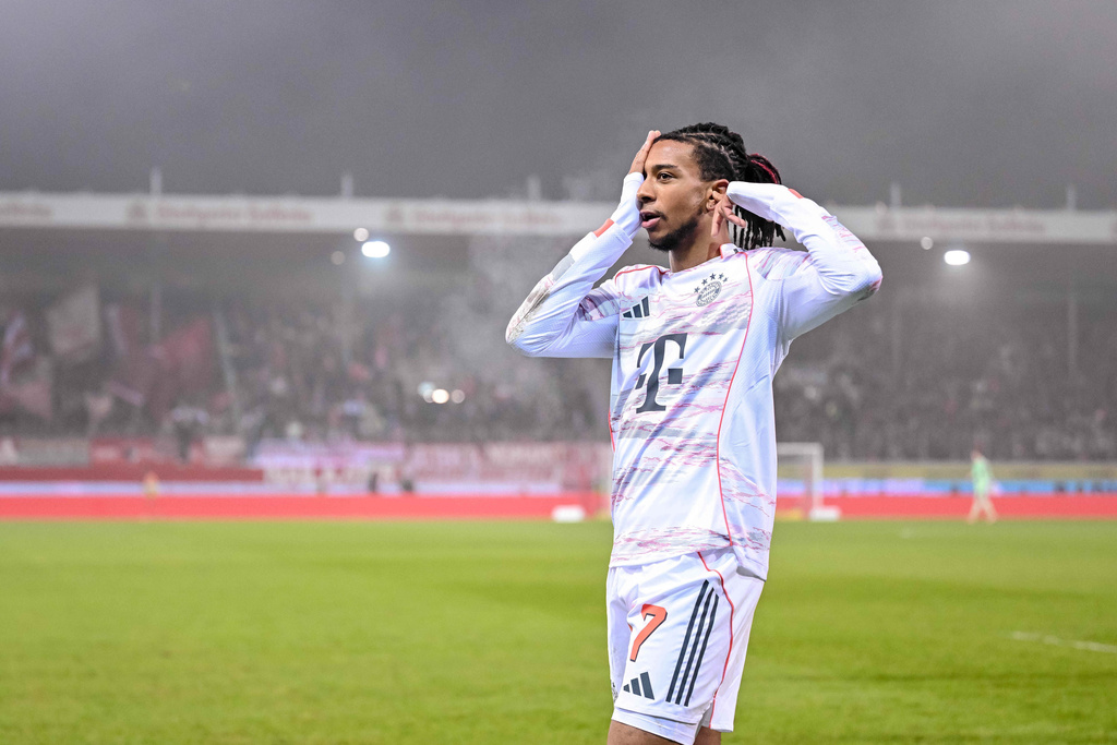 Bayern's Michael Olise celebrates after scoring their side's second goal of the game during the Bundesliga soccer match between FC Heidenheim and Bayern Munich, in Heidenheim, Germany, Sunday Dec. 21, 2025. (Harry Langer/dpa via AP)