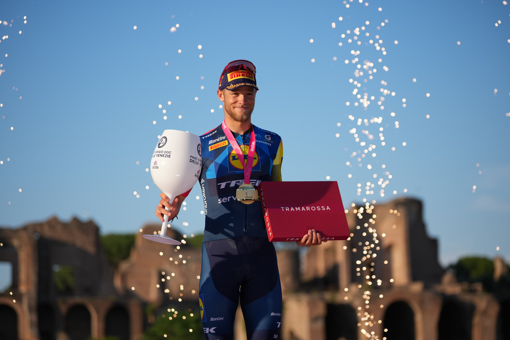 Italy's Jonathan Milan celebrates on the podium after winning the last stage of the Giro d'Italia in Rome Sunday May 31, 2026. (AP Photo/Andrew Medichini)