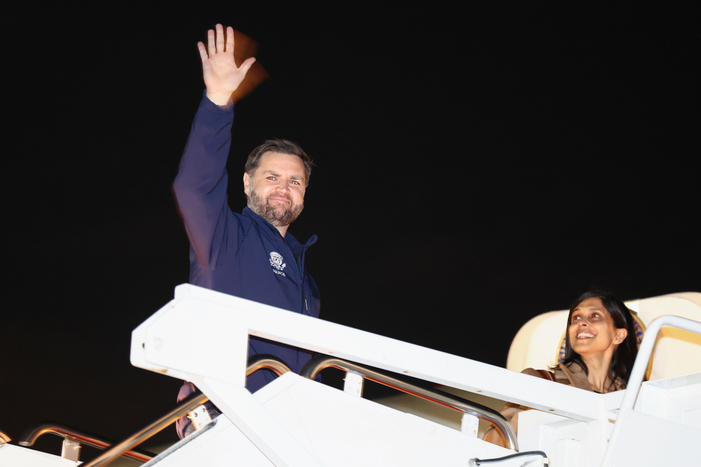 Vice President JD Vance waves as he and second lady Usha Vance board Air Force Two to travel to the Milano Cortina 2026 Winter Olympics in Italy, from Joint Base Andrews, Md., Feb. 4, 2026. (Kevin Lamarque/Pool via AP)