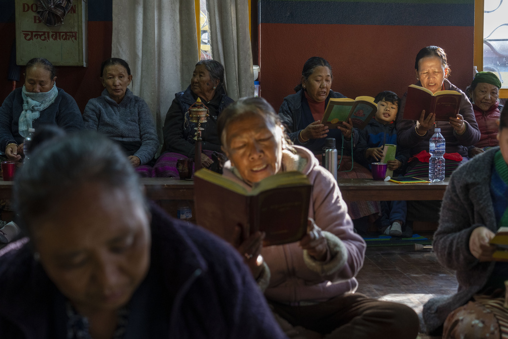 Tibetan people gather to offer prayers in remembrance of those who lost their lives in the recent earthquake, at a Tibetan camp in Lalitpur, Nepal, on Wednesday, Jan. 8, 2025. (AP Photo/Niranjan Shrestha)