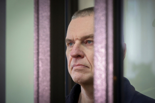 FILE - Journalist Andrzej Poczobut stands in a defendants' cage in court in Grodno, Belarus, on Jan. 16, 2023. (Leonid Shcheglov/Pool via AP, File) FILE - Journalist Andrzej Poczobut stands in a defendants' cage in court in Grodno, Belarus, on Jan. 16, 2023. (Leonid Shcheglov/Pool via AP, File)