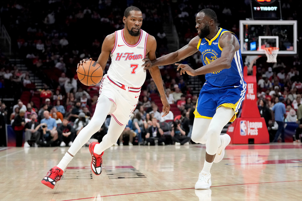 Houston Rockets forward Kevin Durant (7) dribbles as Golden State Warriors forward Draymond Green defends during the first half of an NBA basketball game, Thursday, March 5, 2026, in Houston. (AP Photo/Eric Christian Smith)