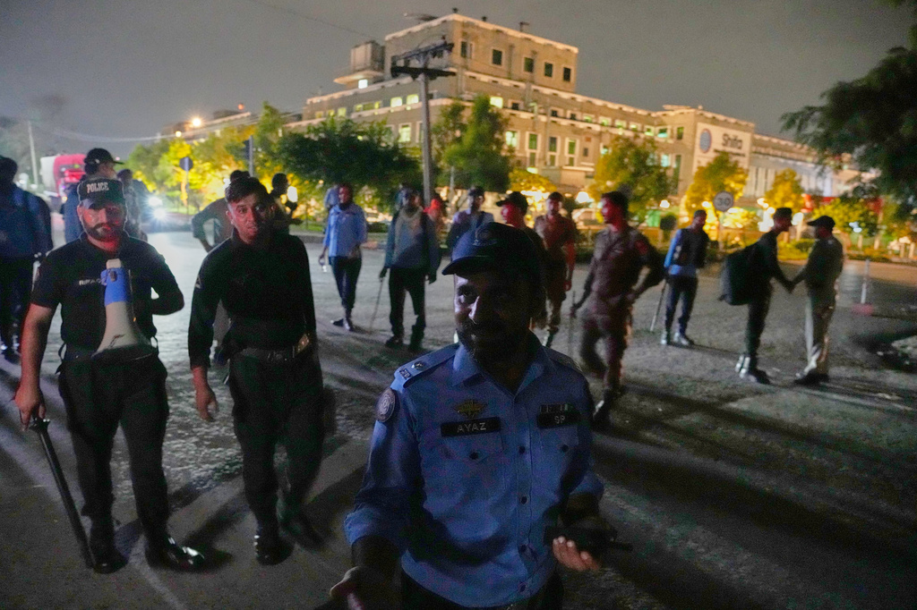 Police officers remove media in front of the Shifa International Hospital, where imprisoned former Prime Minister Imran Khan will be transferred for a medical examination following Pakistan's Supreme Court order, in Islamabad, Pakistan, Thursday, Aug. 20, 2026. (AP Photo/Anjum Naveed)