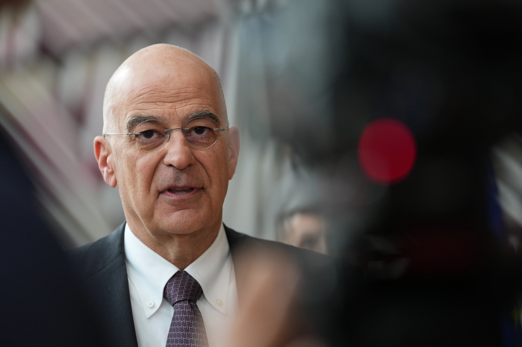 Greece's Defense Minister Nikolaos Dendias speaks with the media as he arrives for a meeting of EU defense ministers at the European Council building in Brussels, Tuesday, May 12, 2026. (AP Photo/Virginia Mayo)